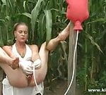 Enema for herself in the garden